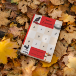 Bird by Bird by Anne Lamott book resting on autumn leaves